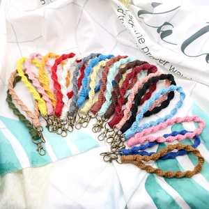 Close-up of handmade spiral braided cotton keychains in various bohemian vibrant colors