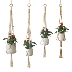 Handmade macrame plant hangers with cotton rope, wooden rings and tassels for home decor