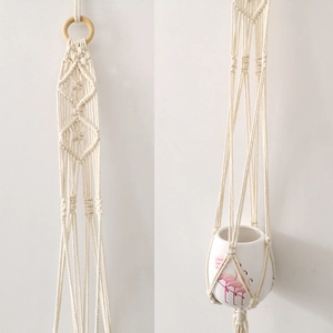 Detail of bohemian macrame plant hanger with wooden ring and handwoven cotton rope knots
