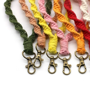 Detail of colorful braided cotton cord keychains with vintage bronze lobster clasps