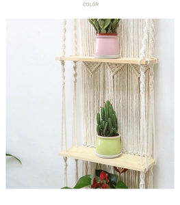 Detailed view of bohemian hand-woven cotton macrame wall hanging with 2-tier wooden shelves