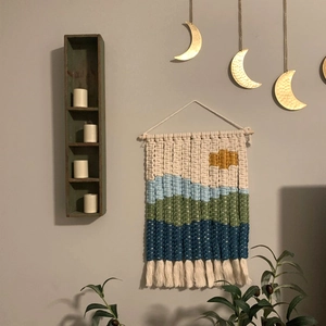 Handmade woven cotton tapestry featuring colorful landscape scenery with tassels