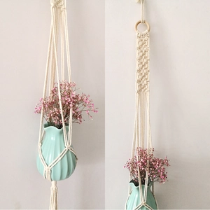 Detail showing the bohemian handmade cotton rope plant hanger with wooden ring and vase
