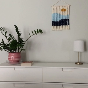 Handmade macrame wall hanging tapestry featuring sunset landscape with fringe tassels