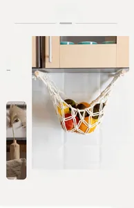 Macro detail of hand-woven macrame fruit hammock with wooden rods and cotton rope