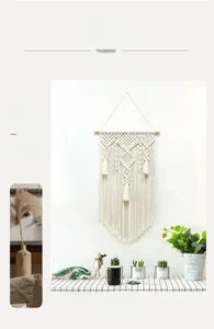 Close-up of Nordic woven cotton tapestry featuring bohemian tassels and wood rod