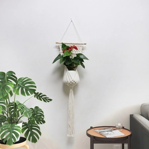 Detail showing handcrafted cotton rope macrame plant hanger with red anthurium in pot