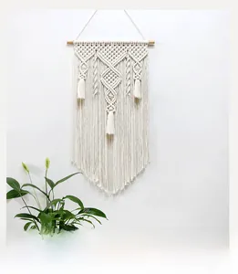 Detailed view of handmade macrame wall hanging with intricate bohemian weaving patterns