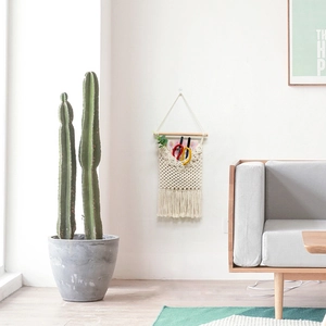 Detailed view of hand-woven bohemian wall storage bag with fringe and cotton texture