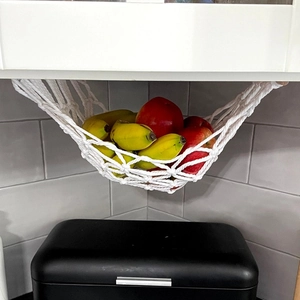 Handmade macrame hanging fruit basket with cotton rope and wooden rods for kitchen storage