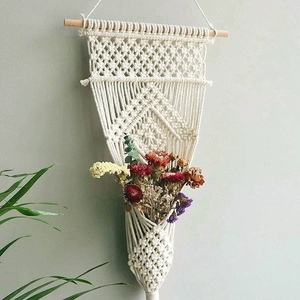 Handmade macrame plant hanger with bohemian cotton weaving and wooden stick wall decor