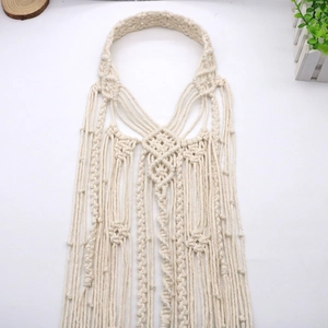 Detailweergave van de crème Macramé geweven katoenen hoofdband met boho franjes en knopen