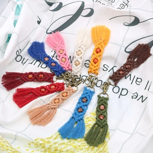 Detailed flat lay of ten colorful macrame fringe keychains with wooden beads