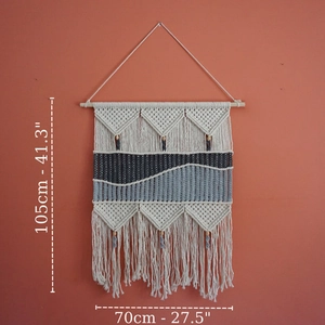 Detail of woven bohemian wall hanging showing blue texture and wood bead accents