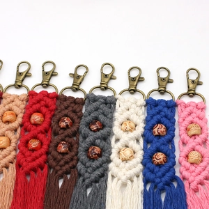 Detail view of handmade woven macrame keychains with colorful wooden beads and long tassels
