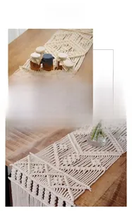 Detailed macro view of bohemian handmade cotton macramé table runner with tassel edges