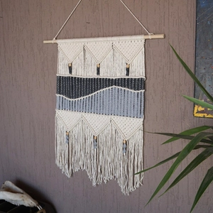 Detailed macro view of woven geometric wave texture on bohemian macrame wall hanging