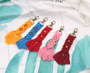 Five pieces of bohemian macrame keychains with colorful cotton fringe and wooden beads