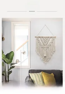 Detailed texture of bohemian handmade woven tapestry with cotton rope fringes