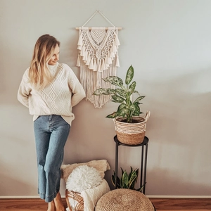 Detailed close-up of macramé wall hanging showing intricate weave patterns and cotton fringe