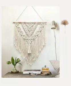 Detailed handcrafted macrame knotting and fringe on a Nordic style woven wall hanging