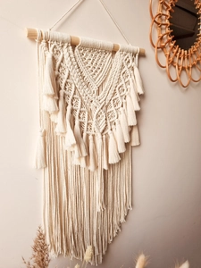 Detailed close-up of bohemian macrame wall hanging with intricate cotton rope weaving