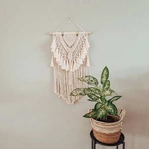 Bohemian hand-woven macrame wall hanging with cotton tassels and wooden pole for home decor