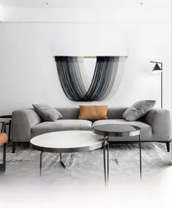 Detail of Nordic grey gradient hand-woven macrame tapestry with wooden support rod