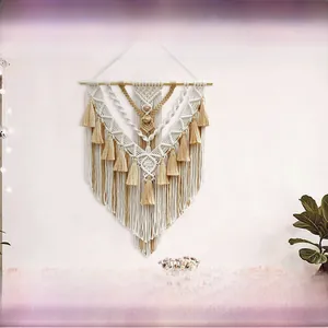 Detail of handmade macrame tapestry with bohemian geometric patterns and long fringes