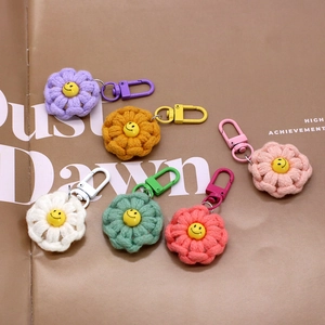 Macro view of colorful hand-knitted flower keychains with smiley face charms and clips