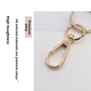 Close-up of golden alloy lobster clasp and split ring with a polished electroplated finish