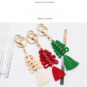 Close-up of handmade woven cotton Christmas tree keychains with beads and tassels