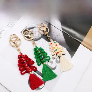 Detail of handcrafted cotton rope woven Christmas tree pendants with beads and tassels