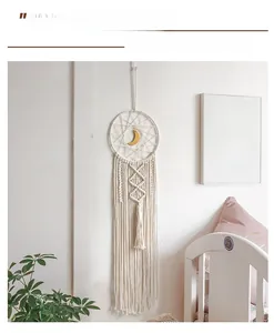 Detailed close-up of handmade Bohemian woven wall hanging with golden moon ornament