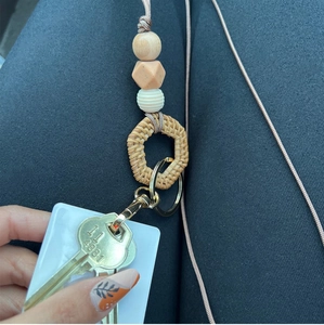 Detail of bohemian beaded lanyard with rattan ring, silicone beads and metal clasp