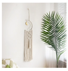 Detail view of woven moon dreamcatcher wall hanging with macrame patterns and fringes