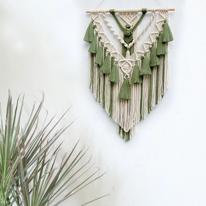 Handmade bohemian macramé wall hanging with cream and olive green fringe decor
