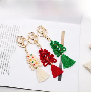 Macro detail of handmade macrame Christmas tree keychains with colorful beads and tassels