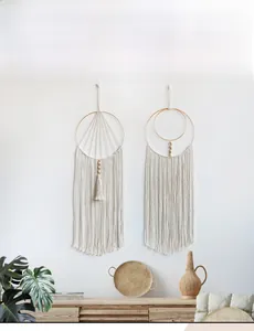 Detailed macro view of bohemian hand-woven cotton macrame dream catchers on a white wall