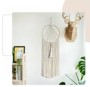 Detail of bohemian handmade woven cotton macrame dreamcatcher with wood beads decoration