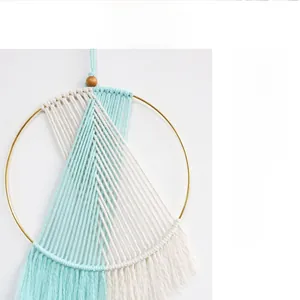 Detail view of Bohemian macrame wall hanging with blue cotton rope and golden metal ring