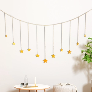 Nordic style hanging wall decoration featuring eleven bright yellow stars on a gold string