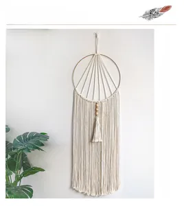 Detailed handmade bohemian macramé wall hanging with metal ring and wood beads