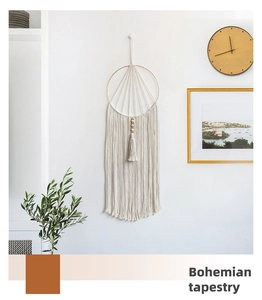 Detailed view of handmade bohemian cotton rope tapestry with macrame fringes and wood beads