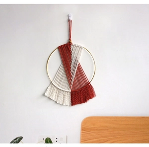 Detail of bohemian round macrame wall hanging with terracotta fringe and woven cotton rope