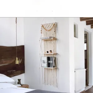 Detail of three-tier boho wall shelf featuring handwoven cotton ropes and wooden beads