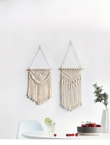 Detail of bohemian hand-woven macrame wall hanging with cotton rope tassels and textures