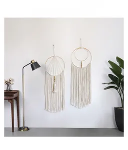Detail of bohemian handmade cotton woven wall hanging with wooden beads and elegant tassels