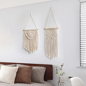 Set of two bohemian hand-woven macrame wall hangings with tassels and wooden rods