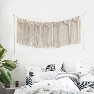Handmade macrame wall hanging with wooden beads and tassels for boho room decor